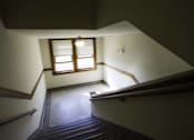 Thumbnail 28 of 100 - A staircase with a window above it.