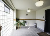 Thumbnail 29 of 100 - A room with a white ceiling, a window with blinds, a plant, and a trash can.