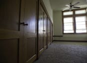 Thumbnail 32 of 100 - A room with wooden doors and a ceiling fan.