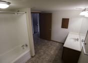 Thumbnail 36 of 100 - A bathroom with a white tub and sink.