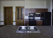 Thumbnail 39 of 100 - A kitchen with a sink and a refrigerator.