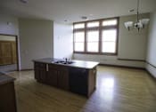 Thumbnail 40 of 100 - A kitchen with wooden floors and a large island.