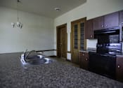 Thumbnail 43 of 100 - A kitchen with a sink and an oven.