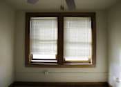 Thumbnail 4 of 100 - A room with a window covered in blinds.