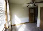 Thumbnail 5 of 100 - A room with a ceiling fan and a door.