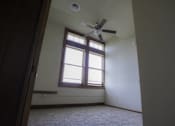 Thumbnail 59 of 100 - A room with a ceiling fan and a window.