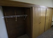Thumbnail 60 of 100 - A wooden closet with a shelf and two doors.