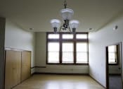 Thumbnail 67 of 100 - A room with a large window and a chandelier hanging from the ceiling.