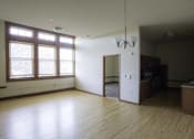 Thumbnail 68 of 100 - A room with wooden floors and a chandelier.