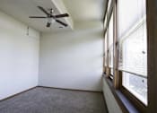 Thumbnail 72 of 100 - A room with a ceiling fan and a window with blinds.