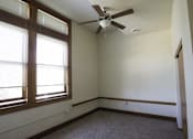 Thumbnail 73 of 100 - A room with a ceiling fan and a window.