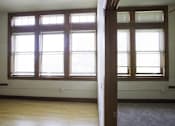 Thumbnail 74 of 100 - A room with a large window and a carpet on the floor.