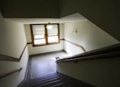 Thumbnail 78 of 100 - A staircase with a window above it.