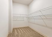 Thumbnail 17 of 29 - Empty room with white walls and shelves.