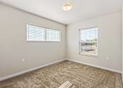 Thumbnail 22 of 29 - A room with beige carpet and two windows with blinds.