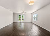 Thumbnail 21 of 29 - A room with wooden flooring and a ceiling fan.