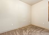 Thumbnail 15 of 29 - A room with a carpeted floor and a painting on the wall.
