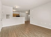 Thumbnail 1 of 16 - A room with wooden flooring and white walls.