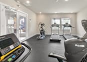 Thumbnail 6 of 16 - A gym with treadmills, elliptical machines, and a treadmill with a digital display.