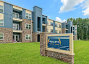 Thumbnail 14 of 16 - A sign in front of a building that says Preserve on it.