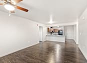 Thumbnail 14 of 32 - A room with a ceiling fan and wooden flooring.