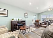 Thumbnail 2 of 32 - A living room with a brown leather couch and a wooden coffee table.