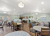 Thumbnail 3 of 32 - A spacious room with a dining table and chairs.