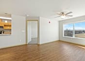 Thumbnail 3 of 27 - A room with a ceiling fan and a large window.