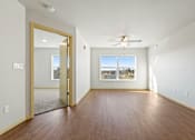 Thumbnail 4 of 27 - A room with a ceiling fan and a large window.