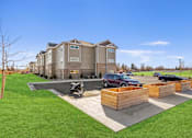 Thumbnail 2 of 27 - A motorcycle is parked on a concrete pad in front of a building.