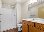 Thumbnail 15 of 27 - A white bathroom with a toilet, sink, and shower.