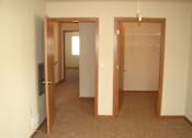 Thumbnail 17 of 18 - A room with a carpeted floor and a white wall.