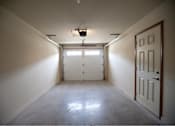 Thumbnail 13 of 15 - A white door is on the right side of a room with a concrete floor.