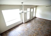 Thumbnail 8 of 15 - A room with a tiled floor and a chandelier.