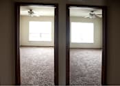 Thumbnail 7 of 15 - Two rooms with carpet floors and ceiling fans.