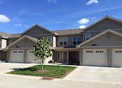 Thumbnail 14 of 15 - A tree is in front of a house with the numbers 1446 and 1448 on the front of the house.