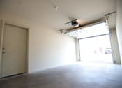 Thumbnail 23 of 25 - A room with a white door and a window with a light on the ceiling.