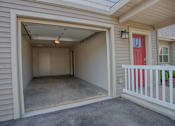 Thumbnail 10 of 25 - A small white room with a red door is attached to a house.