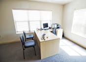 Thumbnail 13 of 25 - A room with a desk and a chair.
