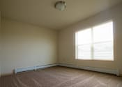 Thumbnail 21 of 25 - A room with a window and a carpet on the floor.
