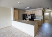 Thumbnail 15 of 25 - A kitchen with a black stove top oven and black microwave.