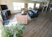 Thumbnail 5 of 25 - A living room with a couch, chairs, and a television.