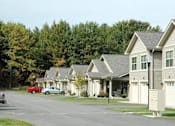 Thumbnail 14 of 21 - A row of houses with cars parked in front.