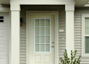 Thumbnail 16 of 21 - A white door with a glass panel is flanked by two white columns.