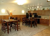 Thumbnail 21 of 21 - A kitchen with a table and chairs.