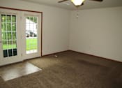 Thumbnail 8 of 18 - A room with a carpeted floor and a ceiling fan.