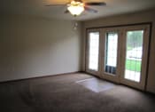Thumbnail 17 of 18 - A room with a ceiling fan and carpeted floor.