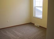 Thumbnail 15 of 18 - A room with a carpeted floor and a window.