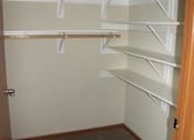 Thumbnail 12 of 18 - Empty white shelves in a room.