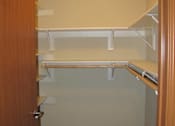 Thumbnail 16 of 18 - A white shelf is mounted on a wall.